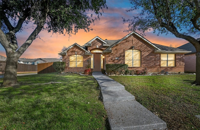 ranch-style home featuring a yard