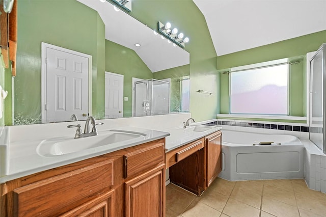 bathroom featuring tile patterned flooring, vanity, vaulted ceiling, and shower with separate bathtub