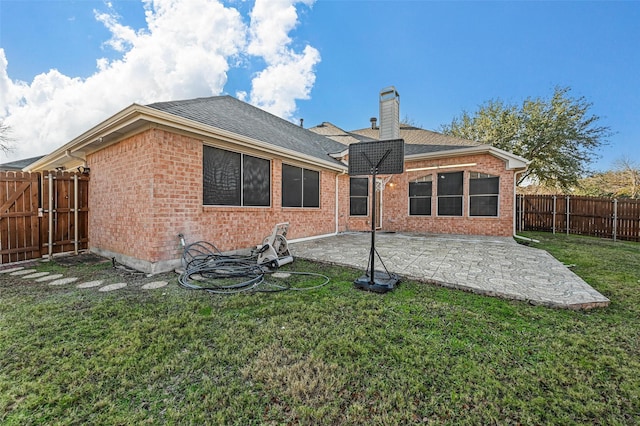 back of house with a yard and a patio area