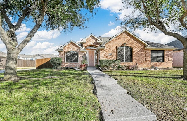 ranch-style home featuring a front yard