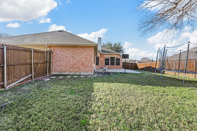 view of yard featuring a patio and a trampoline