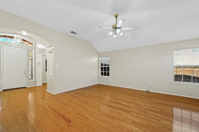 foyer entrance featuring ceiling fan, light hardwood / wood-style floors, and vaulted ceiling