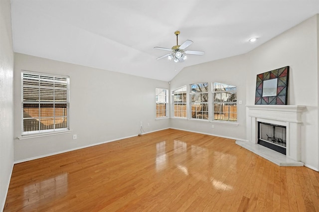 unfurnished living room featuring hardwood / wood-style floors, vaulted ceiling, and ceiling fan