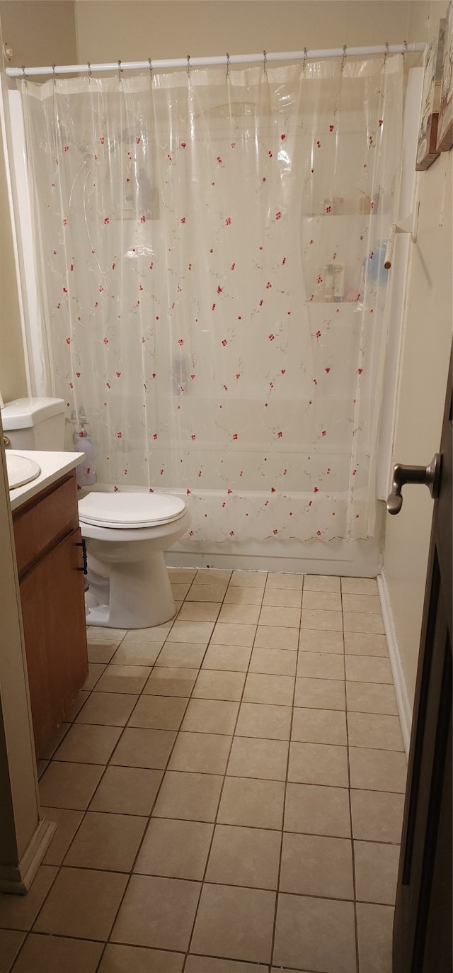 full bathroom featuring tile patterned floors, toilet, vanity, and shower / bath combo