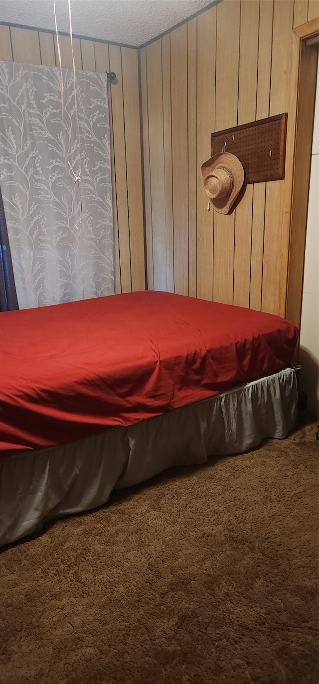 carpeted bedroom with wood walls