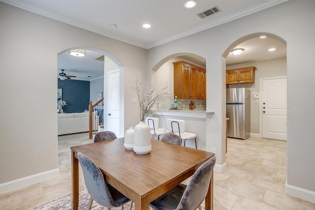 dining area featuring ornamental molding and ceiling fan