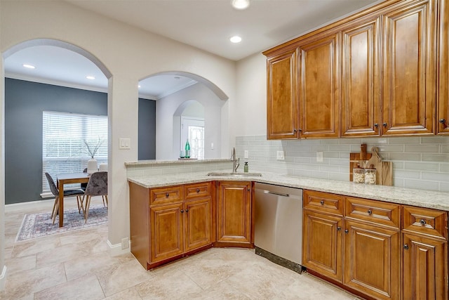 kitchen with tasteful backsplash, sink, ornamental molding, stainless steel dishwasher, and light stone countertops