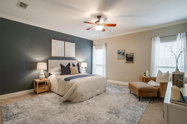 bedroom featuring ceiling fan, ornamental molding, light carpet, and multiple windows