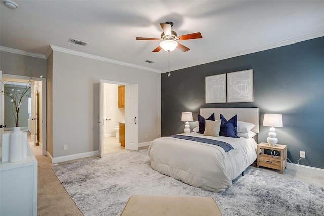 bedroom featuring ceiling fan, light colored carpet, ornamental molding, and ensuite bathroom