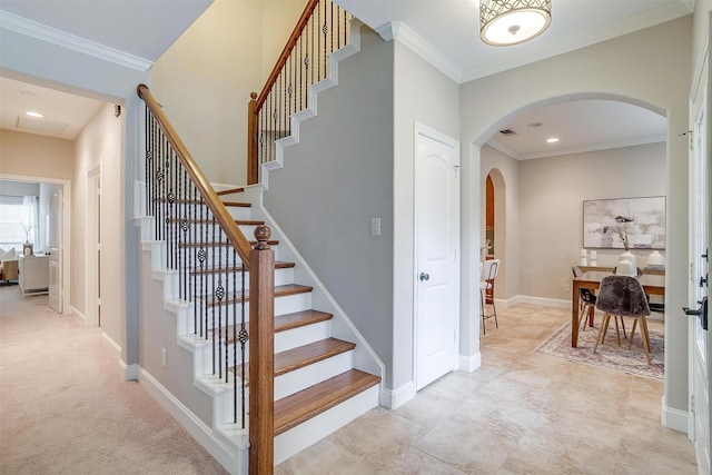 stairs featuring crown molding