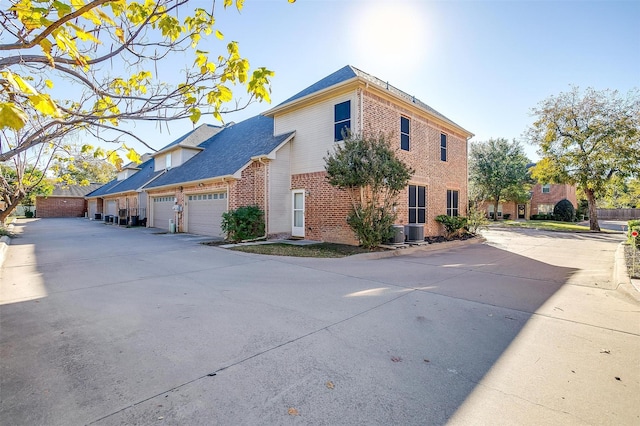 view of home's exterior featuring a garage and cooling unit