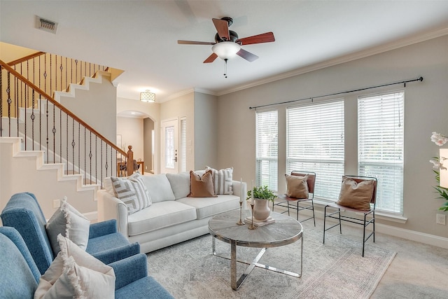 carpeted living room featuring crown molding and ceiling fan