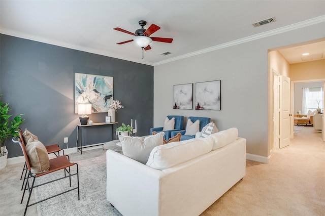 living room with ceiling fan, light colored carpet, and ornamental molding