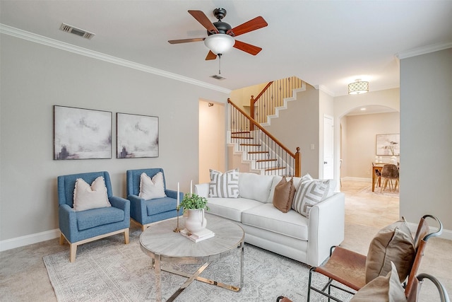 living room with ornamental molding, light carpet, and ceiling fan