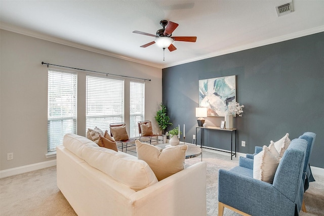 living room with light carpet, ornamental molding, and ceiling fan