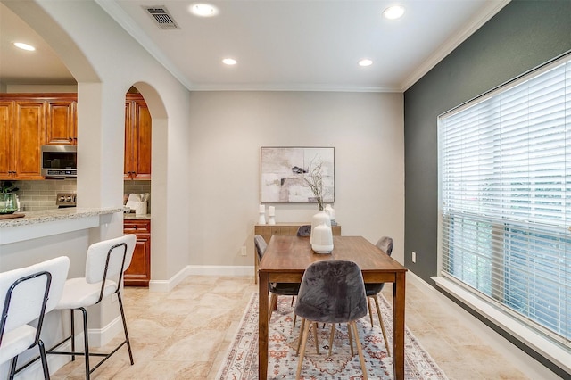 dining room featuring crown molding