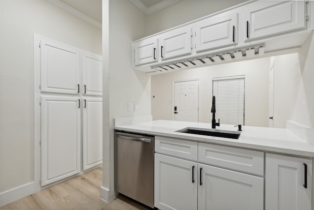 kitchen featuring dishwasher, white cabinets, sink, ornamental molding, and light hardwood / wood-style floors