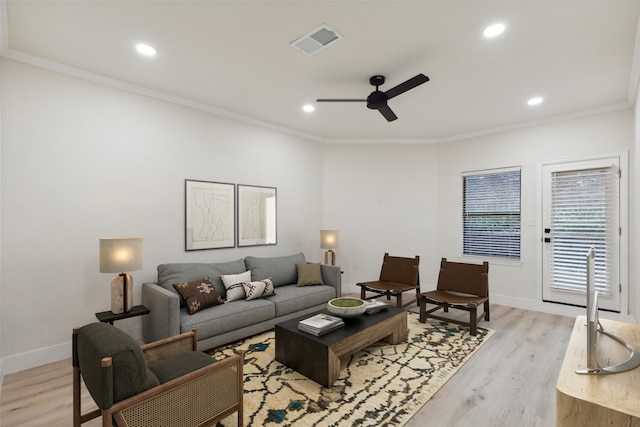 living room featuring ceiling fan, ornamental molding, and light hardwood / wood-style flooring