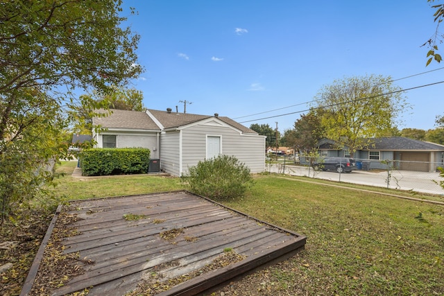 exterior space featuring central air condition unit and a lawn