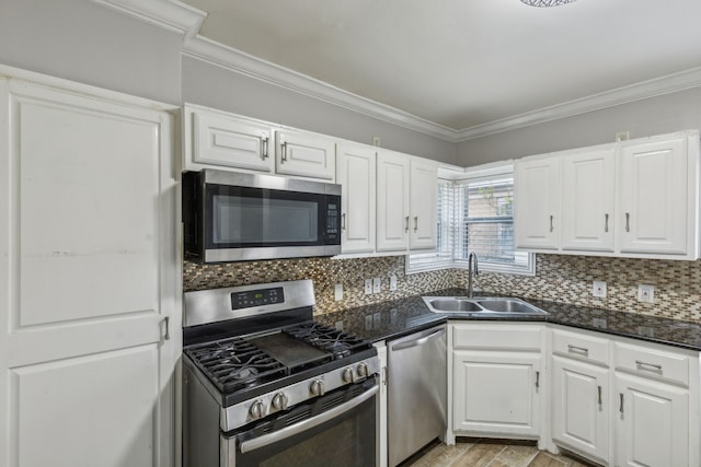 kitchen featuring white cabinets, sink, appliances with stainless steel finishes, and tasteful backsplash