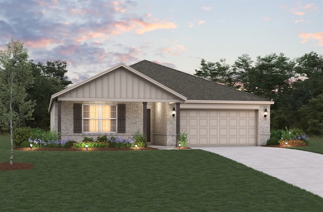 view of front of house with a yard and a garage