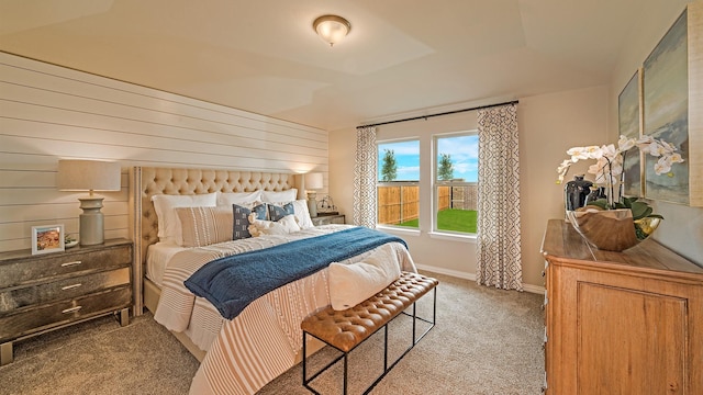 bedroom with light carpet and a raised ceiling