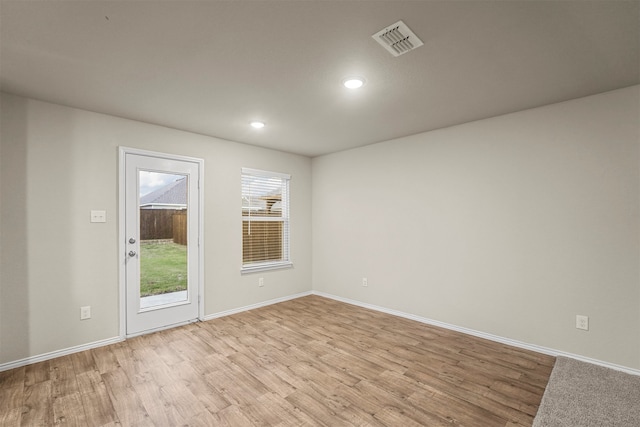 spare room featuring light wood-type flooring