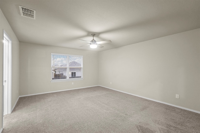 unfurnished room with carpet flooring and ceiling fan