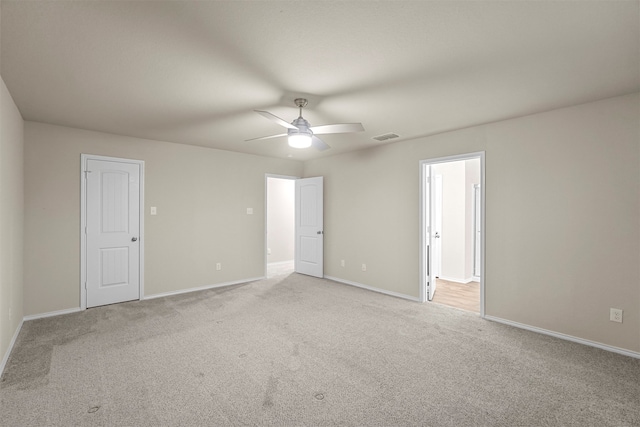 spare room with light carpet and ceiling fan