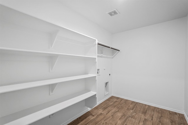 walk in closet featuring hardwood / wood-style flooring