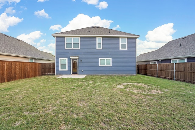 back of property featuring a patio area and a yard