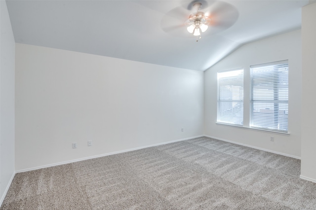 unfurnished room with light colored carpet, vaulted ceiling, and ceiling fan