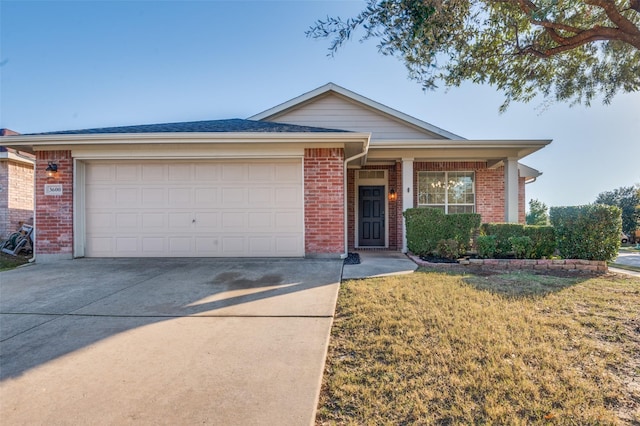 ranch-style house featuring a front yard and a garage