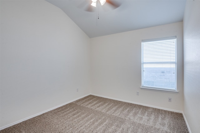 empty room featuring ceiling fan, lofted ceiling, and carpet floors