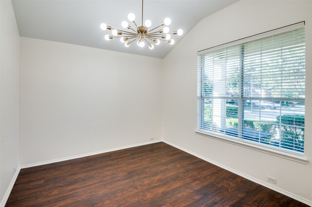 spare room featuring an inviting chandelier, vaulted ceiling, and dark wood-type flooring