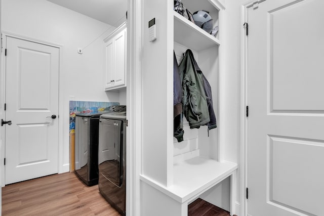 mudroom featuring washing machine and clothes dryer and light wood-type flooring