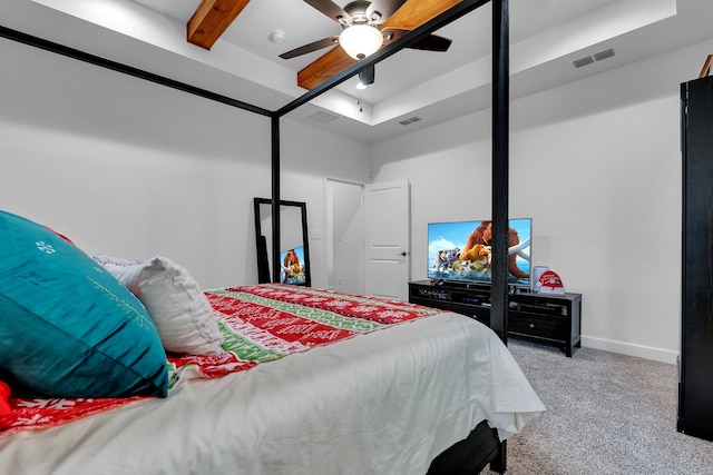 carpeted bedroom with beam ceiling and ceiling fan