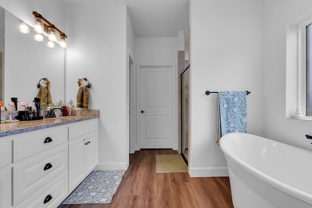 bathroom with separate shower and tub, vanity, and wood-type flooring