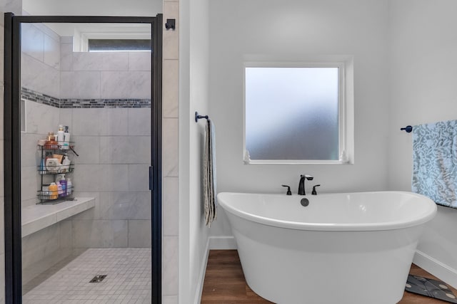 bathroom featuring shower with separate bathtub and hardwood / wood-style flooring