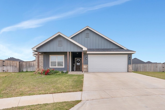 view of front of home featuring a front yard and a garage