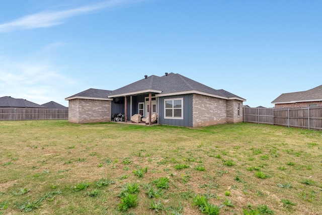 back of property featuring a yard