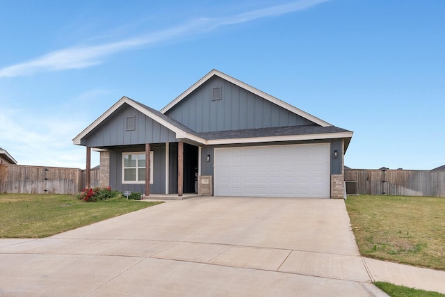 view of front of house with a front yard and a garage