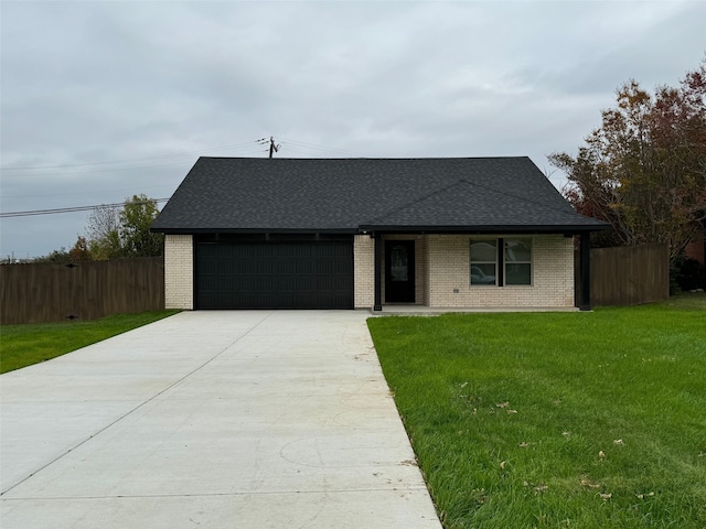 view of front facade with a front lawn and a garage