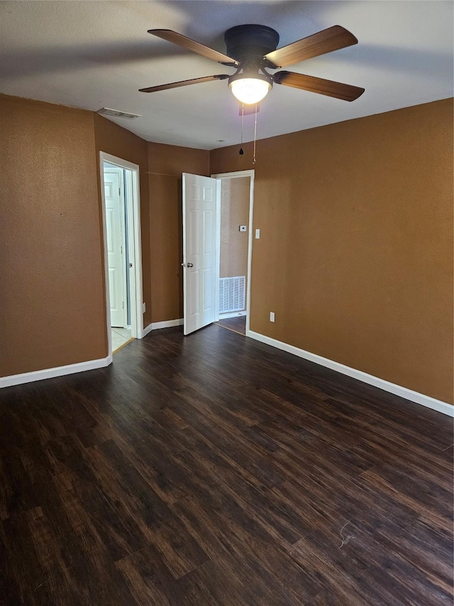 unfurnished room featuring ceiling fan and dark hardwood / wood-style flooring