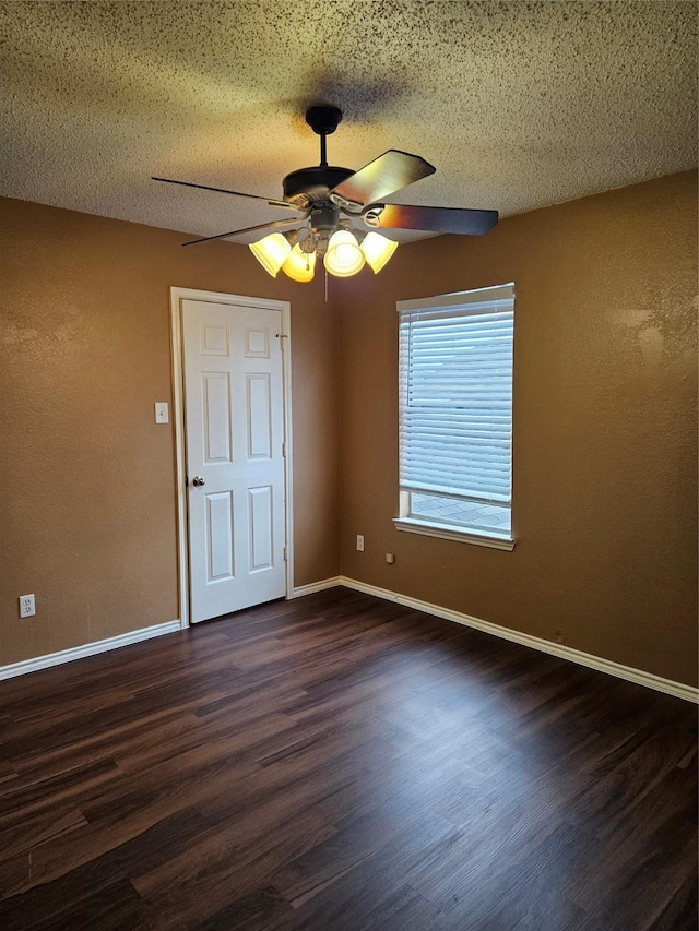 spare room featuring ceiling fan, dark hardwood / wood-style flooring, and a textured ceiling