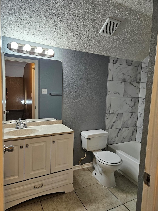 bathroom featuring tile patterned flooring, vanity, a textured ceiling, and toilet