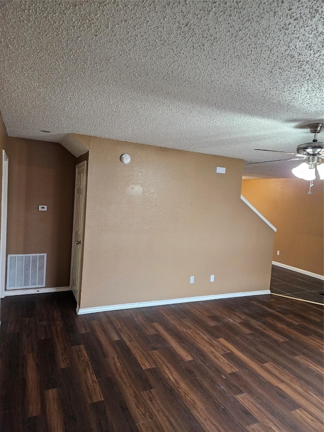 interior space with a textured ceiling, dark hardwood / wood-style floors, and ceiling fan