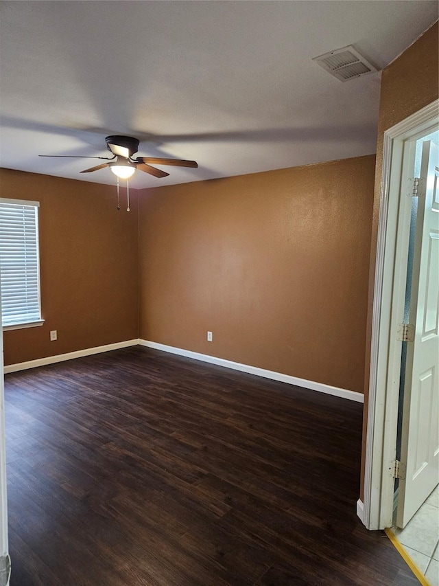 empty room with ceiling fan and hardwood / wood-style flooring