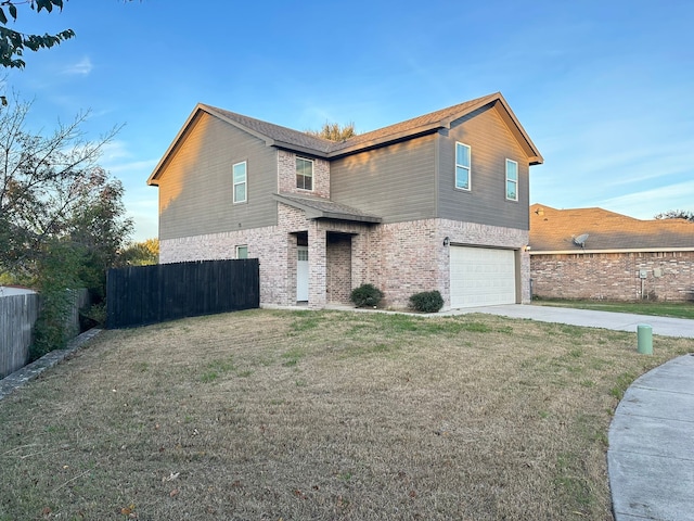 view of front of property featuring a garage and a front lawn