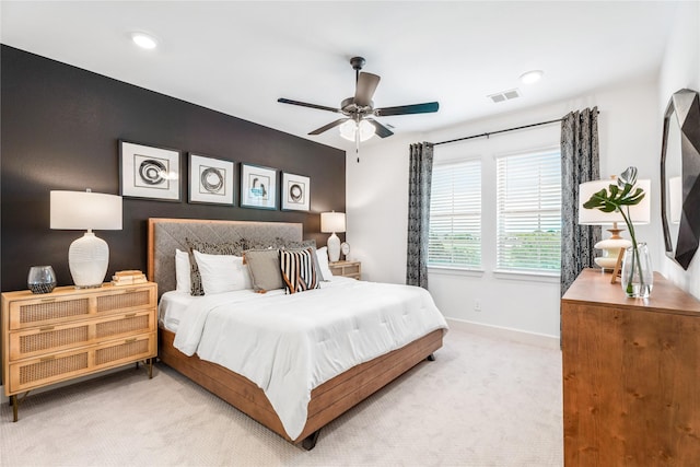 bedroom featuring light colored carpet and ceiling fan